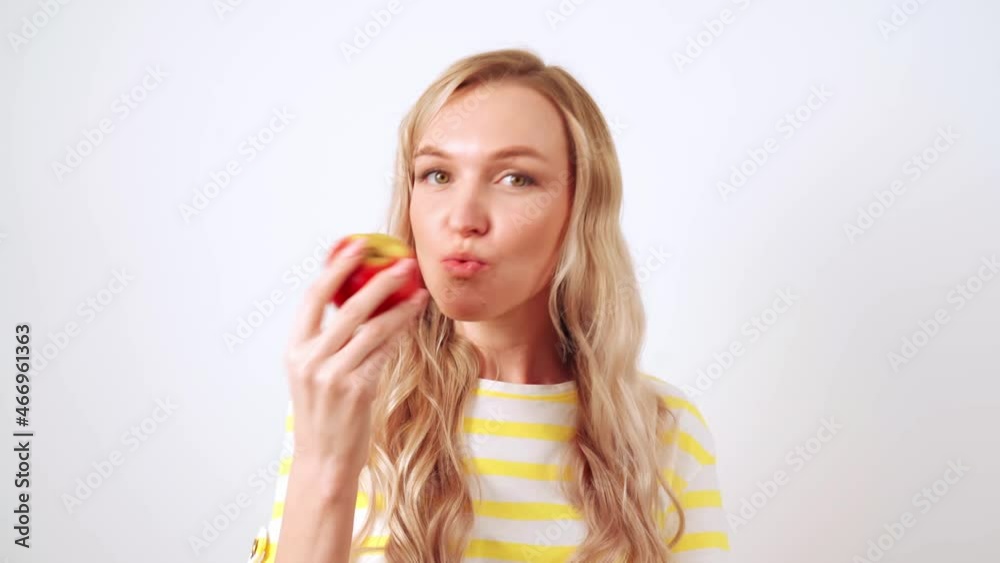 Young blonde woman relaxes on a comfortable sofa in headphones, the girl enjoys listening to music lying on the sofa, relaxing at home.