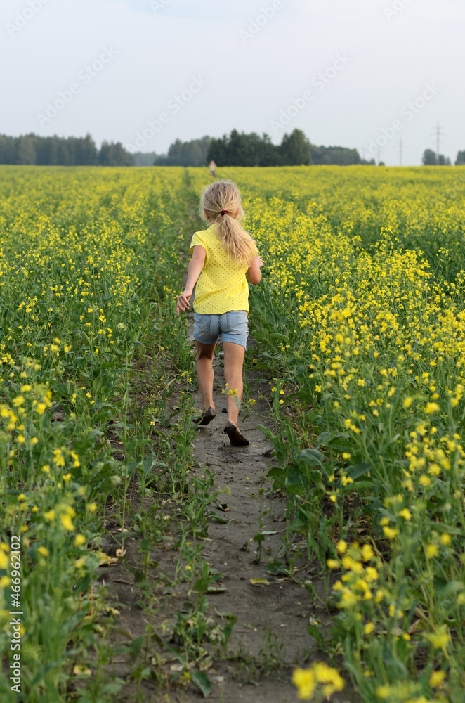 a girl in yellow rapeseed