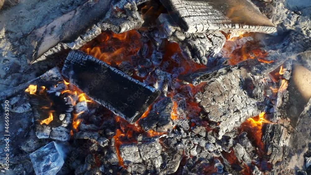 Bonfire with burnt wood in slow motion. Bonfire with burnt wood in slow motion.