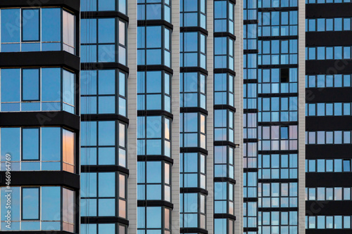 a fragment of the glass facade of a multi-storey building under construction