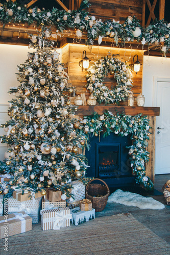 Festive interior: Christmas tree and fireplace gifts. The concept of Christmas and New Year. © aaalll3110