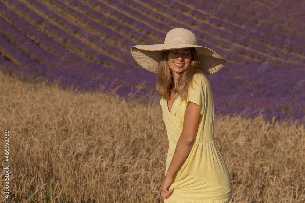 Obraz premium meeting of two worlds: a girl in a yellow dress between a wheat and lavender field