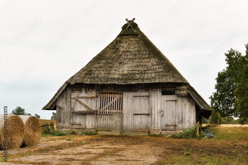 Old thatched barn. Romantic landscape of the Lüneburg Heath, Lüneburger Heide. Historic sheepfold near Undeloh, district of Harburg, Lüneburg Heath Nature Reserve, Lower Saxony, Germany. Old thatched barn. Romantic landscape of the Lüneburg Heath, Lüneburger Heide. Historic sheepfold near Undeloh, district of Harburg, Lüneburg Heath Nature Reserve, Lower Saxony, Germany.