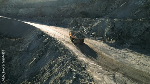 Open pit iron ore mining, a big yellow mining truck at work, working in a quarry, big yellow heavy truck in open cast mine, mining of iron ore, the overall plan, Dump Truck, sunny day