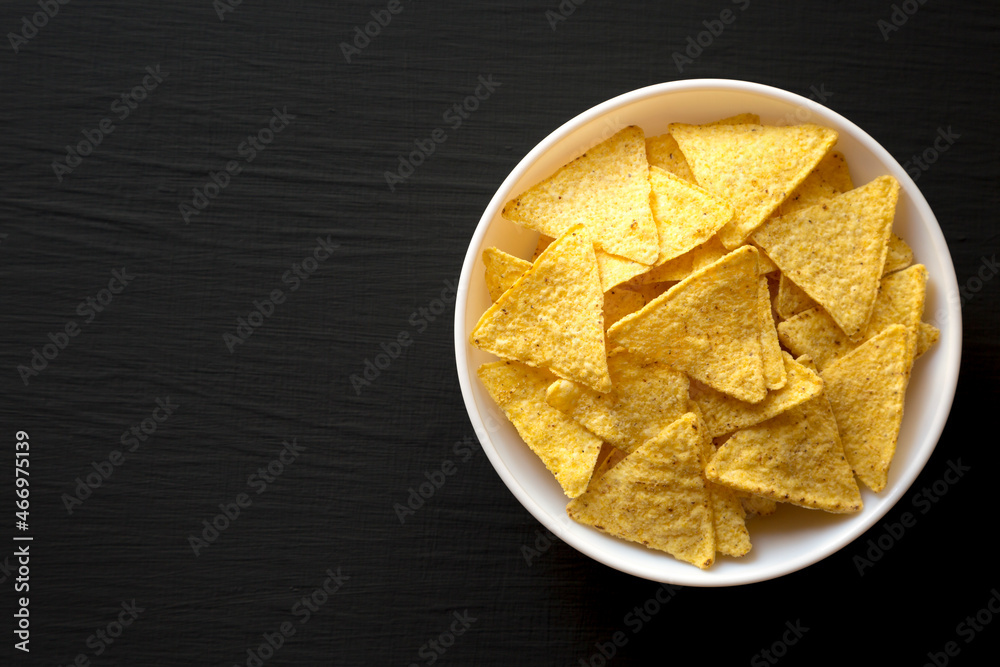 Corn Tortilla Chips in a Bowl, overhead view. Flat lay, from above, top view. Copy space. Corn Tortilla Chips in a Bowl, overhead view. Flat lay, from above, top view. Copy space.