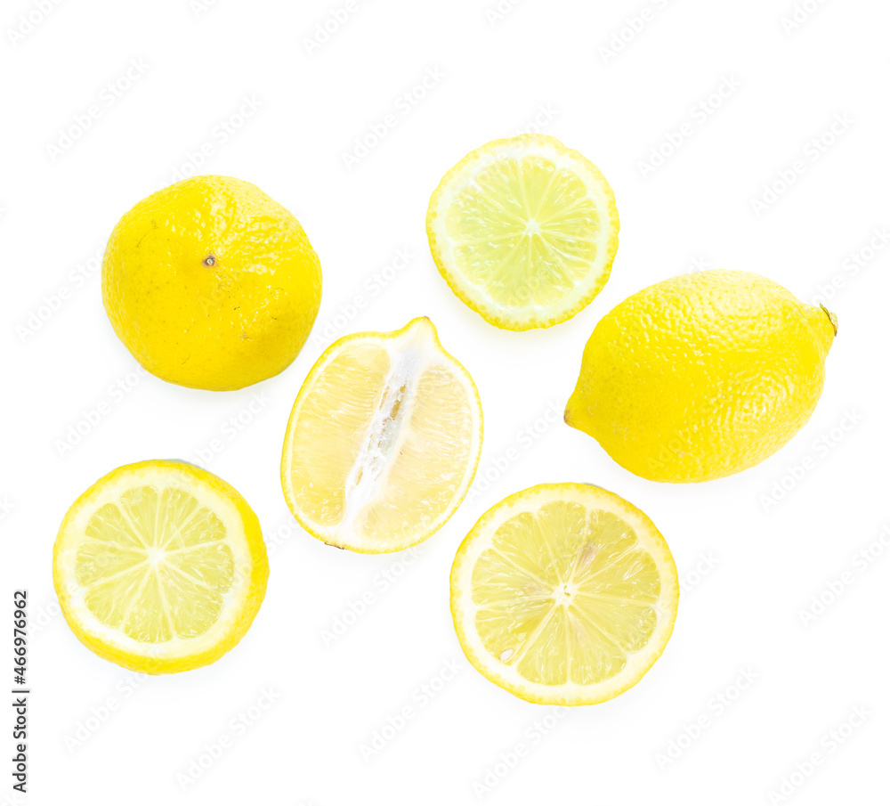 Fototapeta premium Whole and half lemons on white background 