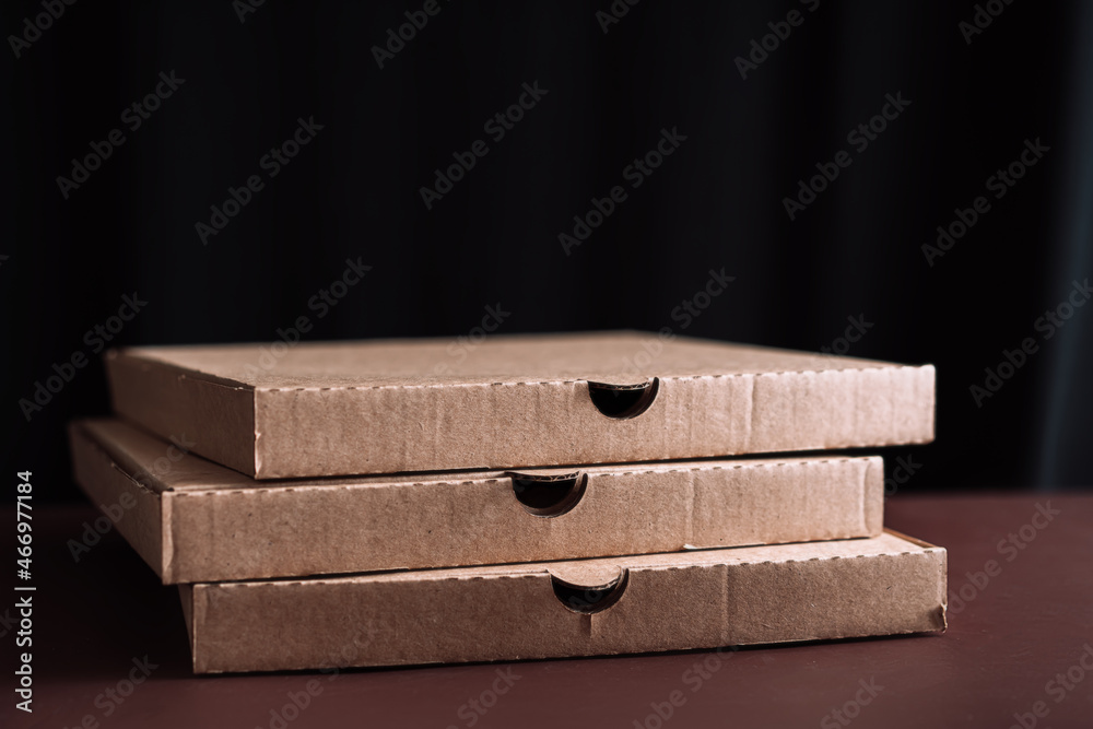Three pizza boxes stacked on top of each other Three pizza boxes stacked on top of each other