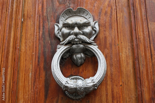 Vintage brass door knocker on an old door, Italy, Rome
