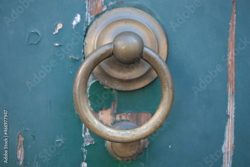 Vintage brass door knocker on an old door, Italy, Rome