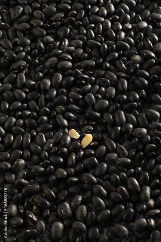 Products background. Small black beans texture. Vegetarian and vegan organic food. Vertical position