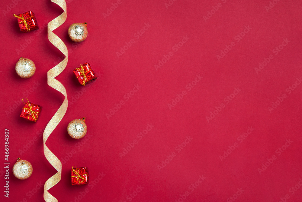 New Year or Christmas border or background with golden ribbon, golden balls and gifts on red background, copy space. Mockup for postcards, business cards and other festive materials New Year or Christmas border or background with golden ribbon, golden balls and gifts on red background, copy space. Mockup for postcards, business cards and other festive materials