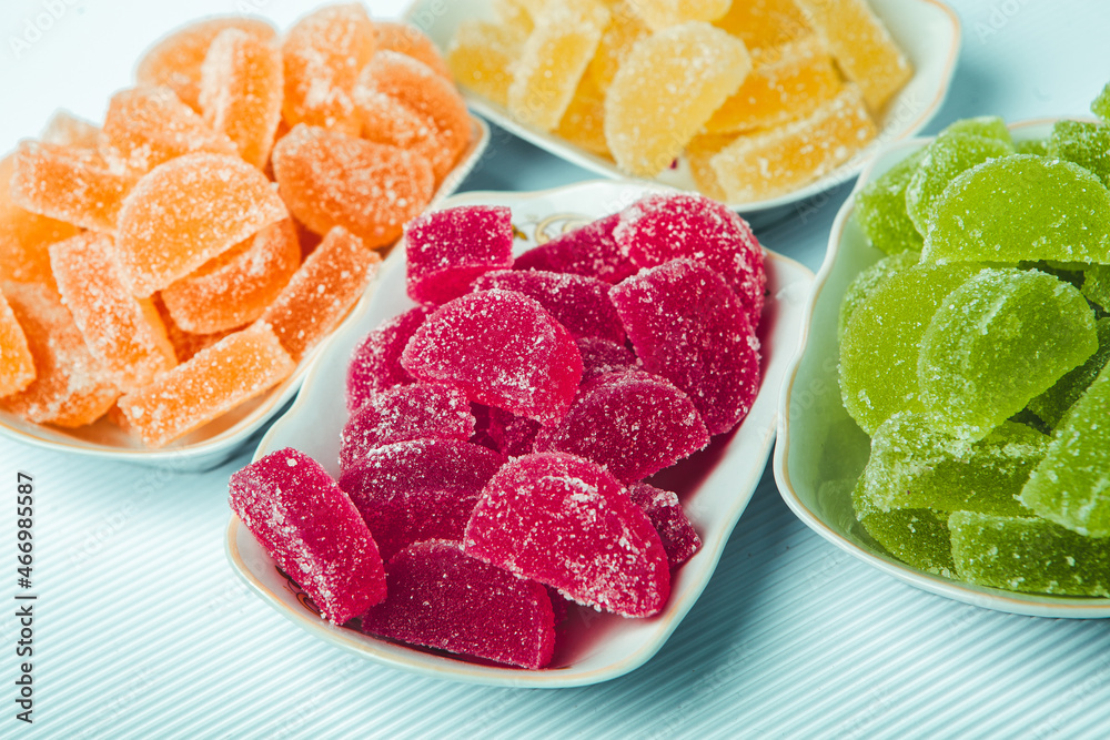 Dessert marmalade in the form of lemon and orange slices. The sweetness of jelly candy.