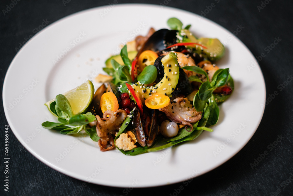 Salad with seafood, avocado, shrimp, octopus and pepper.