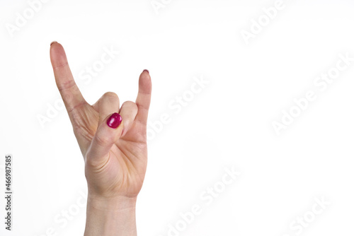 Canvastavla a woman's hand with a pink nail polish on it, making a peace sign with her fin