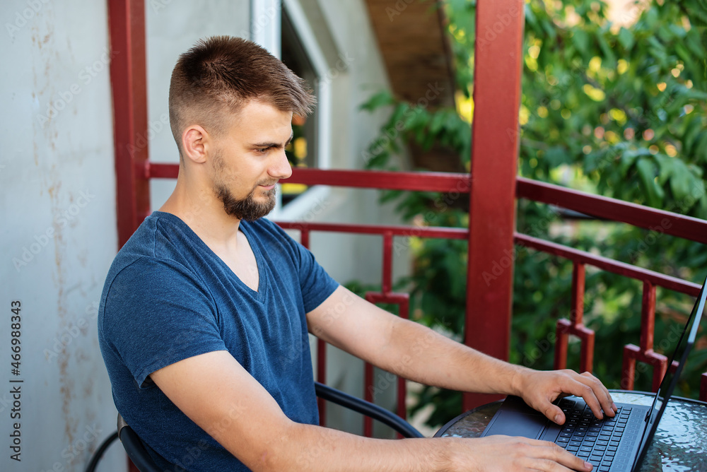 A bearded young man is using computer laptop for working at outdoors, working freelance project online outdoors at home, handsome student studying, learning, online education, freelancer A bearded young man is using computer laptop for working at outdoors, working freelance project online outdoors at home, handsome student studying, learning, online education, freelancer