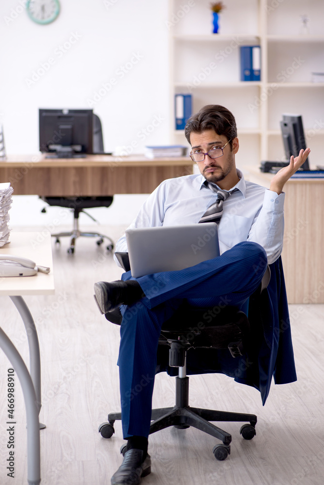 Young male employee working in the office Young male employee working in the office