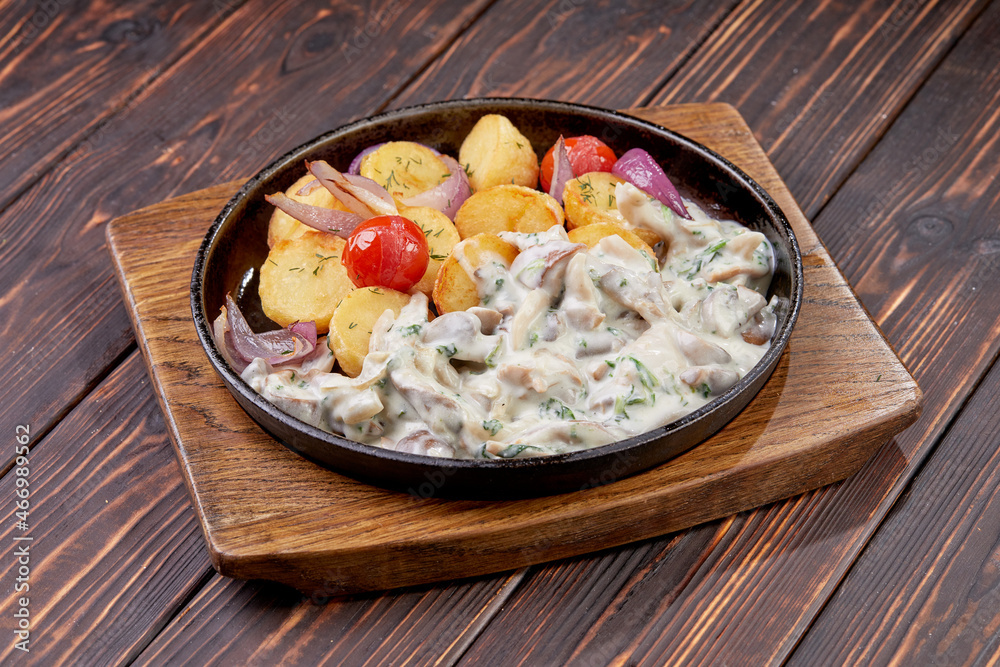 Rustic style fried pork with potatoes and mushrooms Rustic style fried pork with potatoes and mushrooms