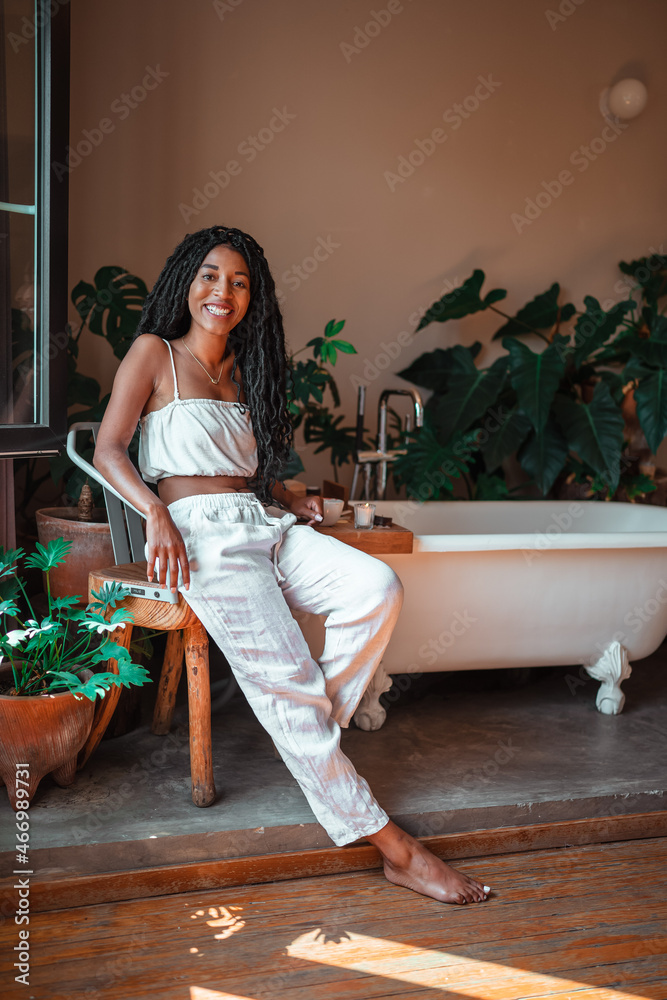 black girl sitting on the edge of her window