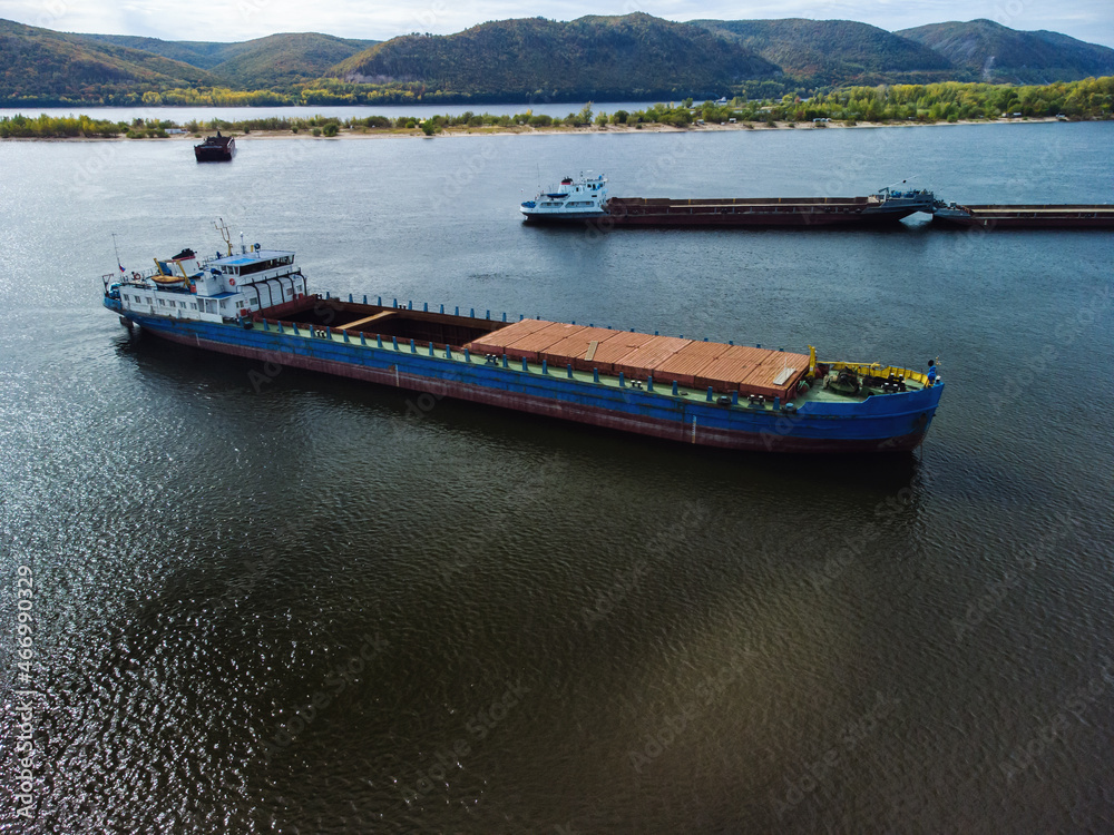 Fototapeta premium Aerial view of unloaded dry cargo ships on river.