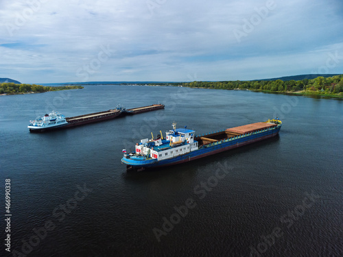 Aerial view of unloaded dry cargo ships on river.