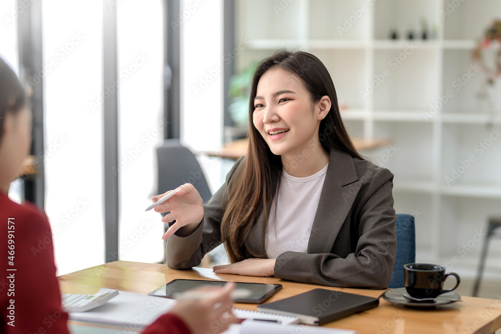 Two young Asian businesswoman work together at office. Two young Asian businesswoman work together at office.