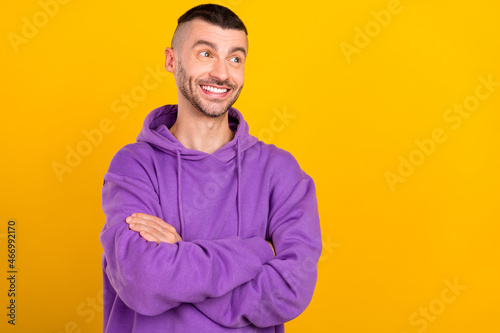 Photo portrait young man wearing violet sportswear with crossed hands looking copyspace isolated vibrant yellow color background