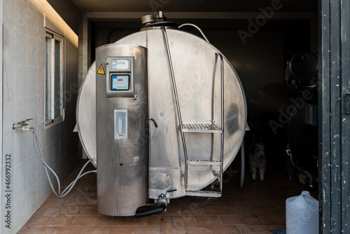 Milk cooling tank in a dairy farm. Milk storage and cooling. Dairy industry concept.