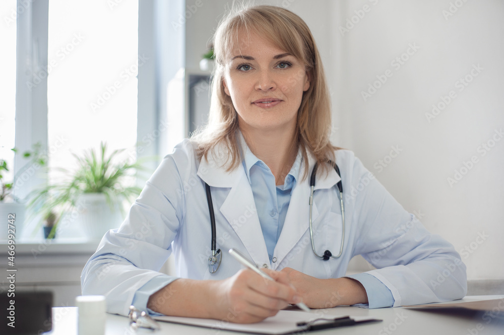 The doctor is in his office. Beautiful smart woman doctor is conducting a consultation. Remote medical consultation and telemedicine concept. Clinic work. The doctor is in his office. Beautiful smart woman doctor is conducting a consultation. Remote medical consultation and telemedicine concept. Clinic work.