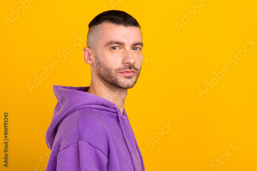Profile side view portrait of attractive suspicious guy copy blank space ad isolated over bright yellow color background