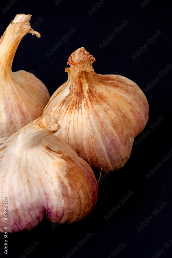 garlic on a black wooden background	