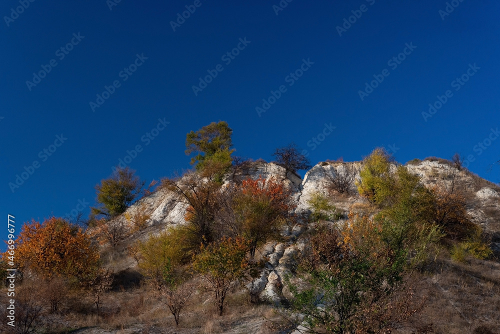 landscape of autumn trees mountains on a background of blue sky golden autumn cold often turns into snow, and then again come warm sunny days. landscape of autumn trees mountains on a background of blue sky golden autumn cold often turns into snow, and then again come warm sunny days.
