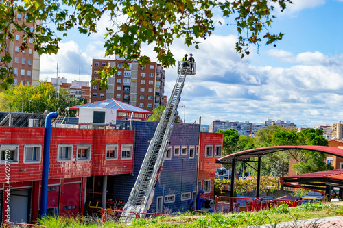 MADRID  SPAIN - NOVEMBER 3  2021. Firefighters climb a scale of a truck in one of the trainings in the fire station  in Madrid  Spain. Europe.