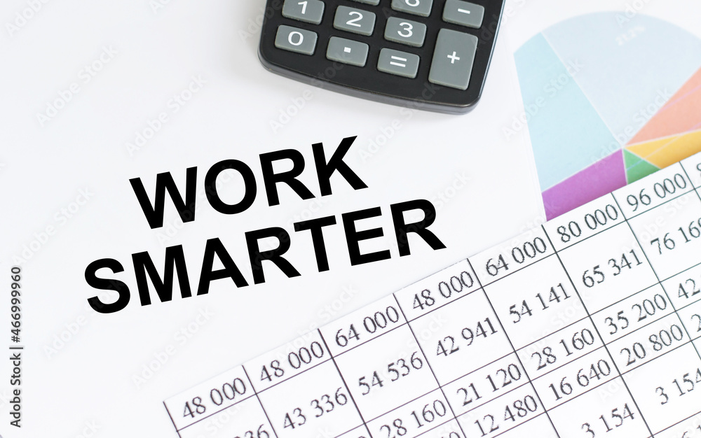 Work Smarter, Business Concept. Notebooks, calculator, charts and report sheets Work Smarter, Business Concept. Notebooks, calculator, charts and report sheets