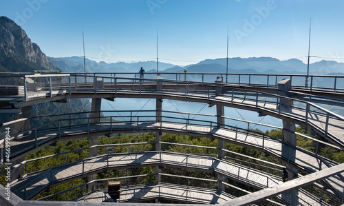 The unique panoramas from the walk and observation tower Baumwipfelpfad Salzkammergut on the top of Grunberg. Vacation and weekend activity in Upper Austria. Female posing at the top of the tower. photo