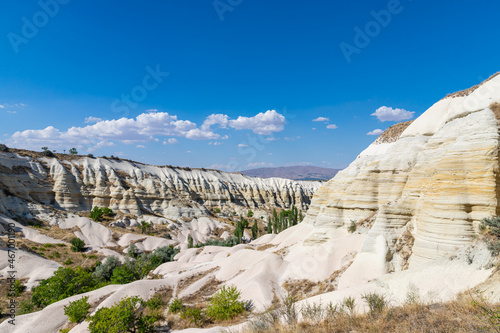 Panorama of unique geological formations in Love valley at sunny day in Cappadocia, Central Anatolia, Turkey.