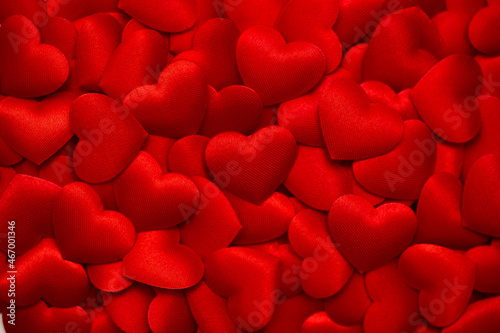 Background from hearts. Red hearts on a red background top view. Background for love flat lay.