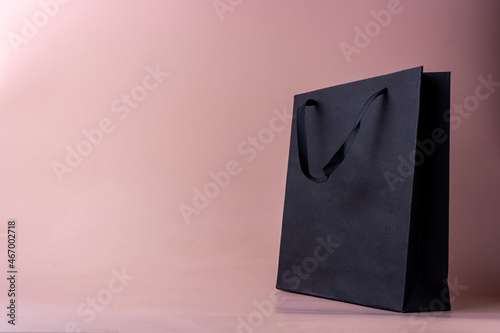 black paper bag on pink background Boxing day