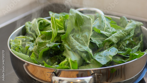 Leaves of green Chard (Beta vulgaris), being grilled in a pot