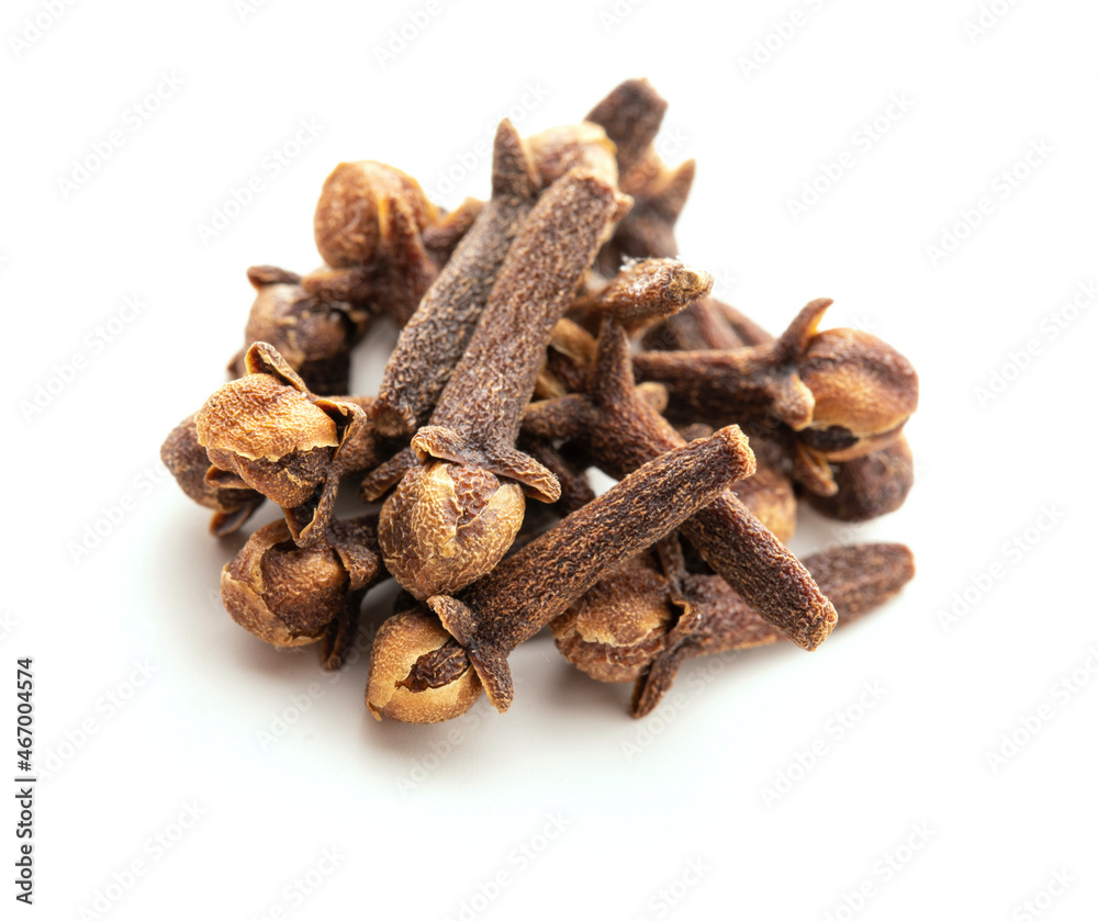 Dry cloves on white background. Pile of spice cloves macro close-up. Dry cloves on white background. Pile of spice cloves macro close-up.