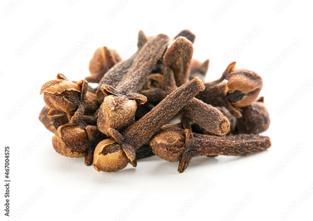 Fototapeta premium Dry cloves on white background. Pile of spice cloves macro close-up.