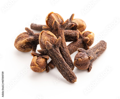 Dry cloves on white background. Pile of spice cloves macro close-up.
