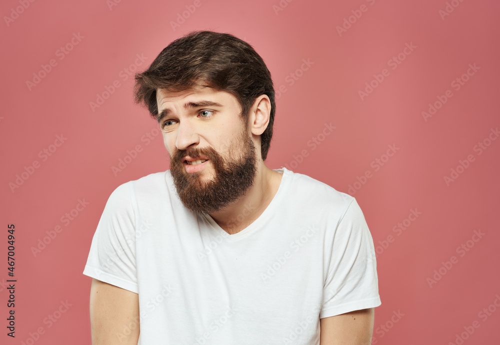 emotional man in a white t-shirt irritated facial expression Studio emotional man in a white t-shirt irritated facial expression Studio