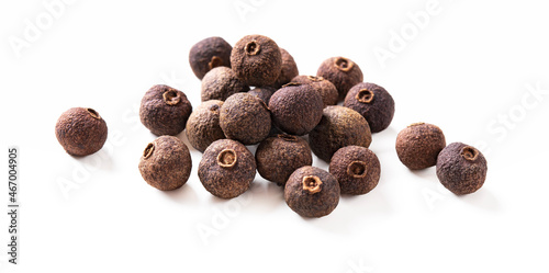 Pile of allspice pepper isolated on white. Jamaica pepper, pimento spice, allspice peppercorns or myrtle pepper. Macro. Clipping path.
