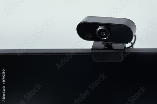 Webcam above computer screen. Black webcam above black screen. Digital security concept