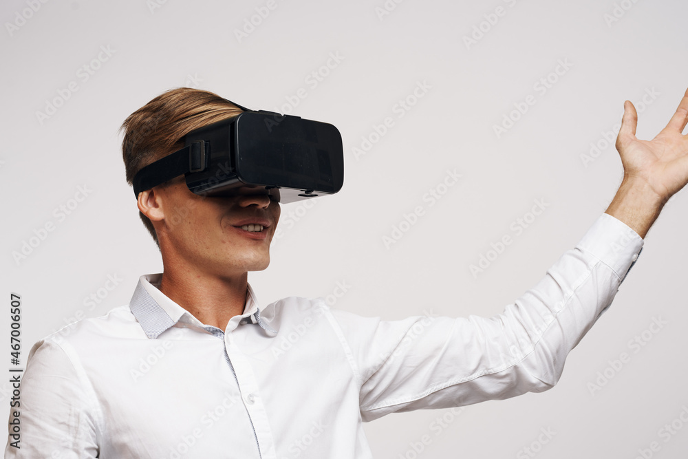 Man in a white shirt vr glasses gadget device video light background Man in a white shirt vr glasses gadget device video light background
