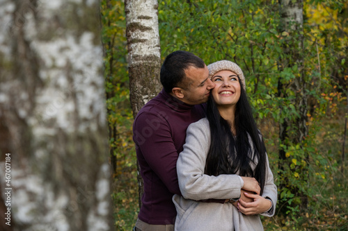 Beautiful young couple in autumn forest on a sunny day © asayenka