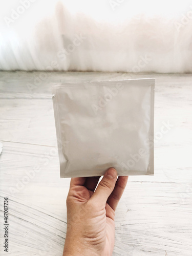 Hand holding a blank plastic pouch