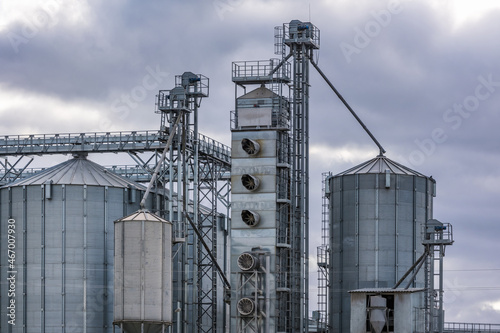 modern granary elevator and seed cleaning line in silver silos on agro-processing and manufacturing plant for storage and processing drying cleaning of agricultural products  flour  cereals and grain