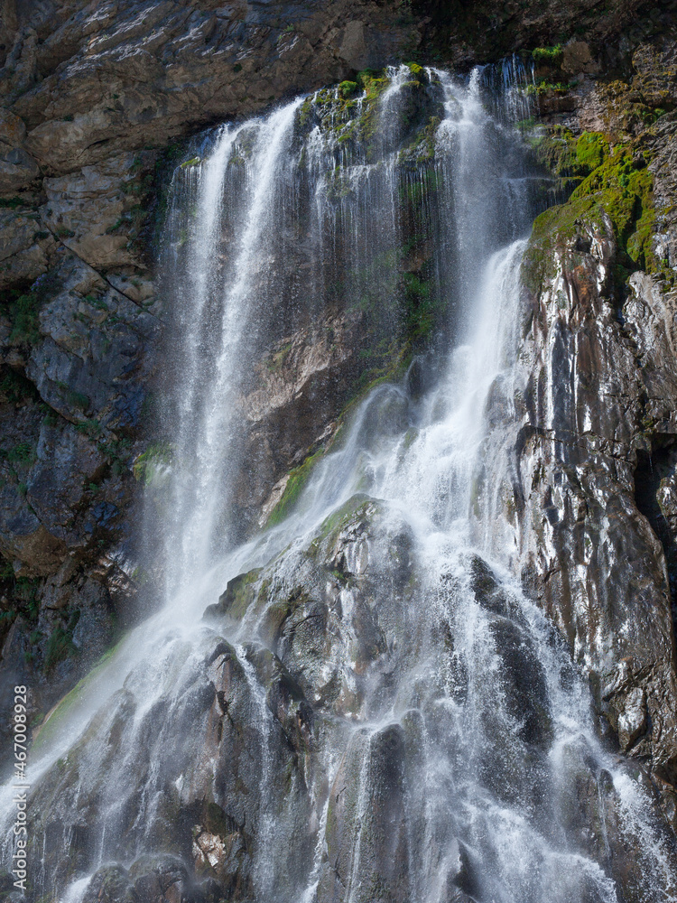 Waterfall on gray green stone rock texture background Waterfall on gray green stone rock texture background