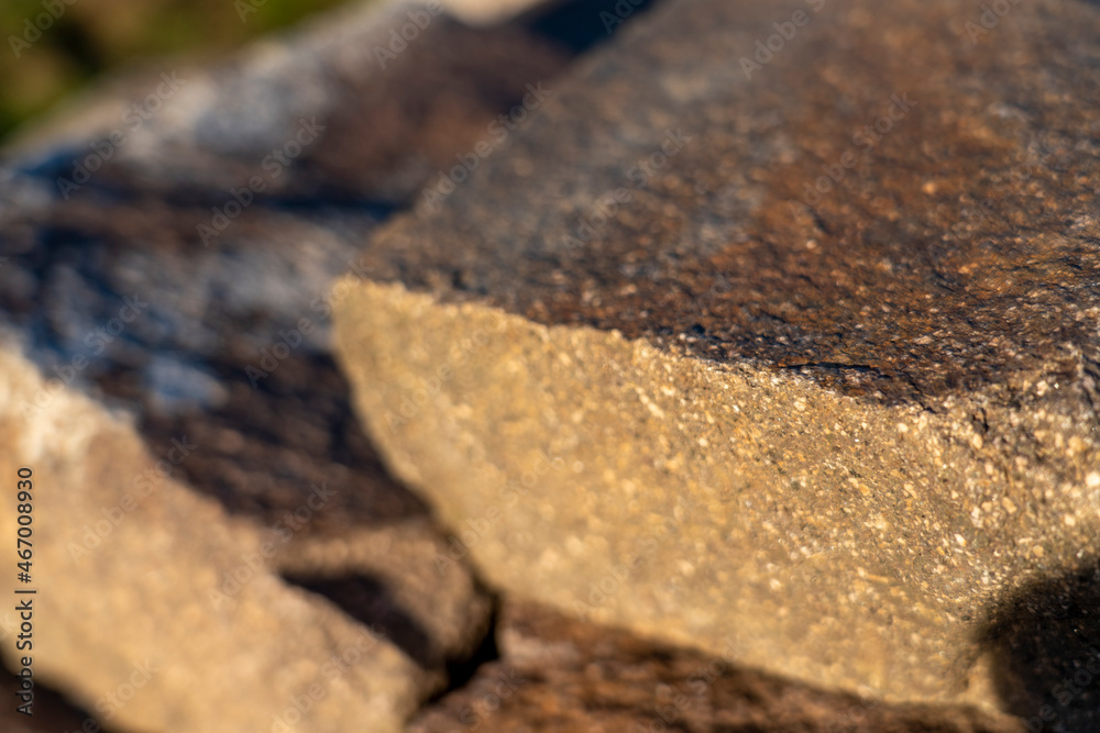 A pile of natural stones lying in the evening sun, Natural stone background A pile of natural stones lying in the evening sun, Natural stone background